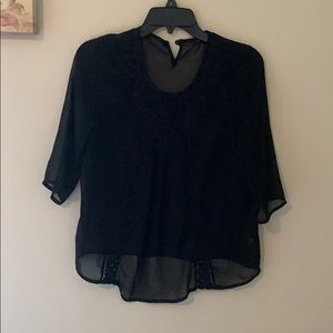 Black blouse with lace design on the front